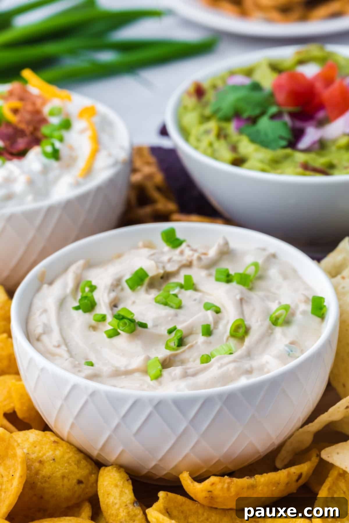 Quick & Creamy French Onion Dip 6 A small bowl of french onion dip garnished with green onions.