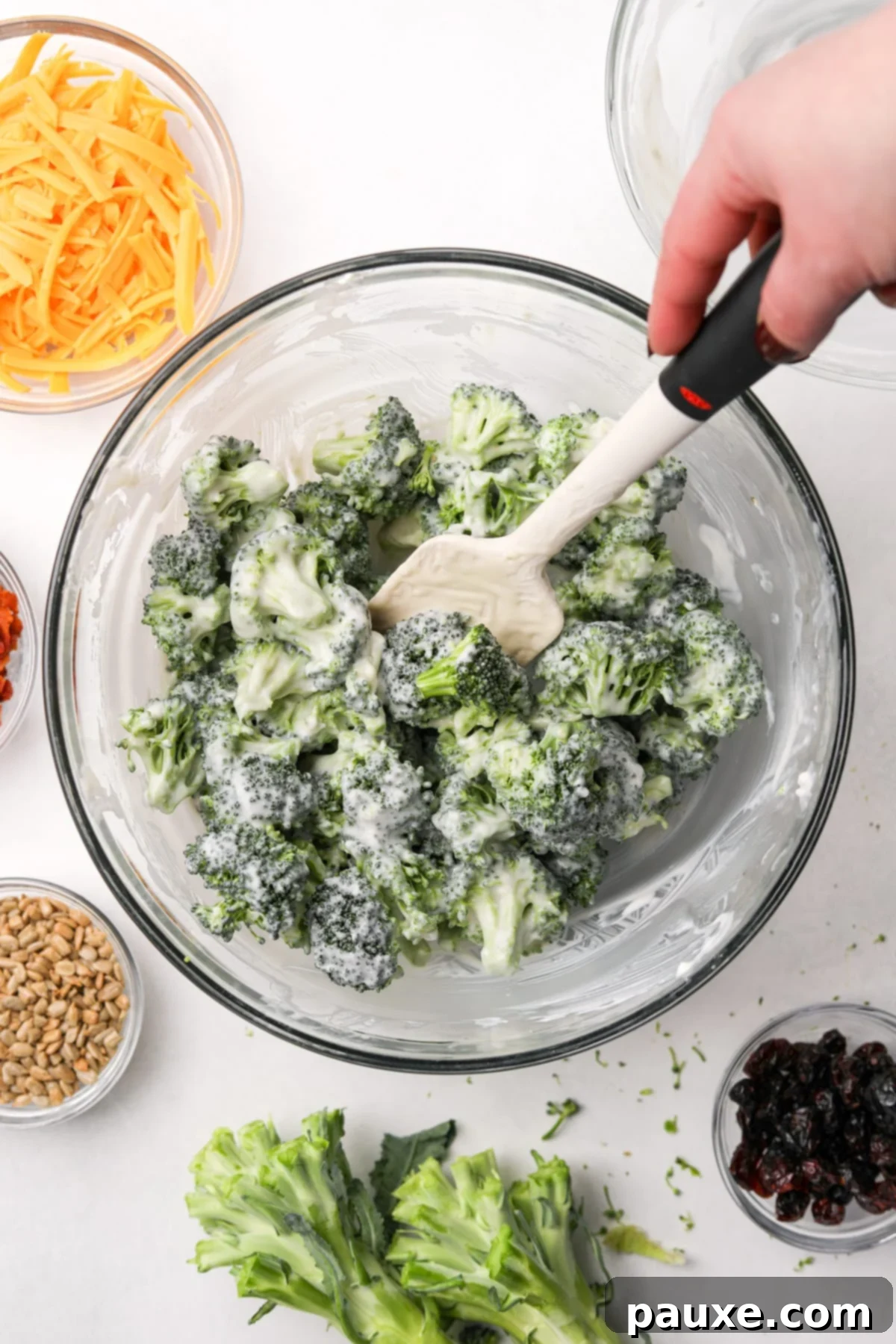 Creamy Crunch Broccoli Salad 8 A bowl of broccoli with a creamy dressing fully coated and evenly distributed through the florets.