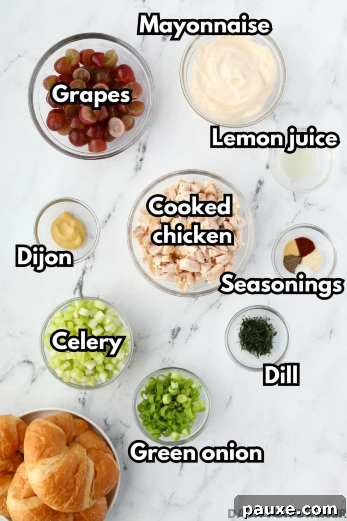 The array of ingredients needed for creamy chicken salad, including cooked chicken, fresh grapes, celery, green onion, and mayonnaise.