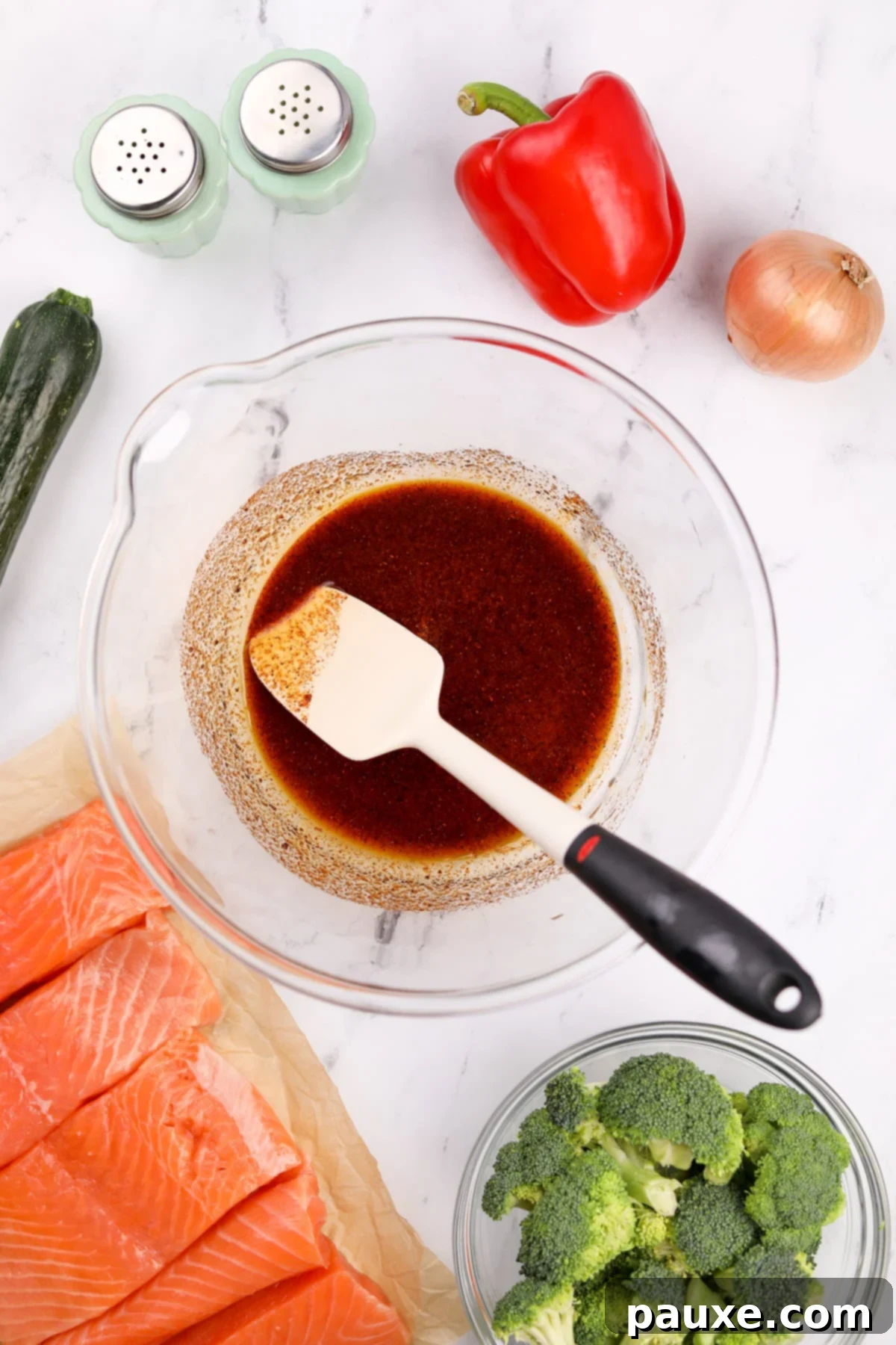 A large bowl with olive oil and seasonings mixed together.