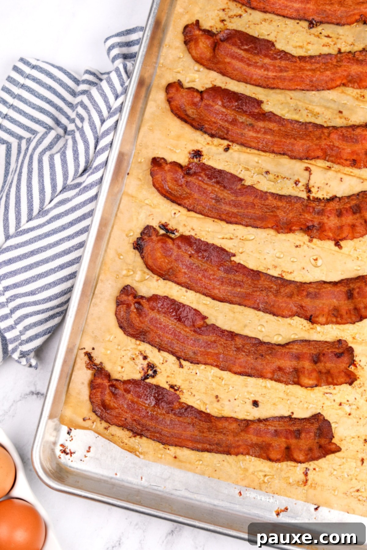 Perfectly Crispy Oven Bacon 2 A baking sheet filled with perfectly cooked crispy bacon, ready to be enjoyed.