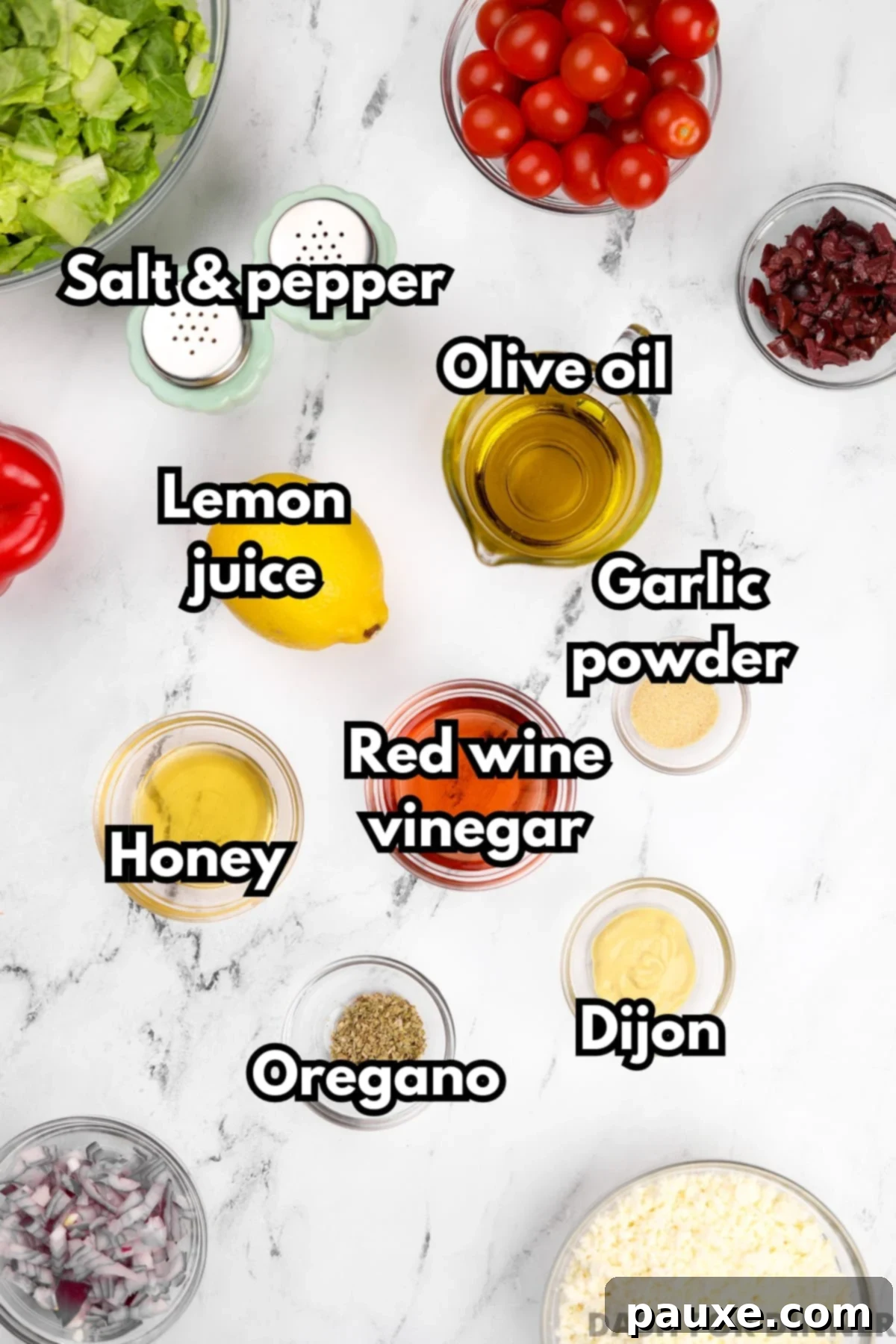Zesty Mediterranean Vinaigrette 3 The key ingredients for homemade Greek dressing, arranged artfully, including a bottle of olive oil, red wine vinegar, a lemon, honey, Dijon mustard, and dried oregano.