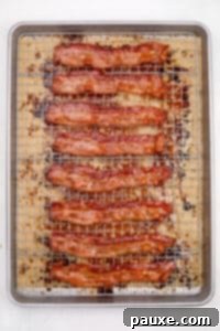 Crispy Caramelized Bacon 18 Crispy cooked bacon on a wire rack set inside of a baking sheet.