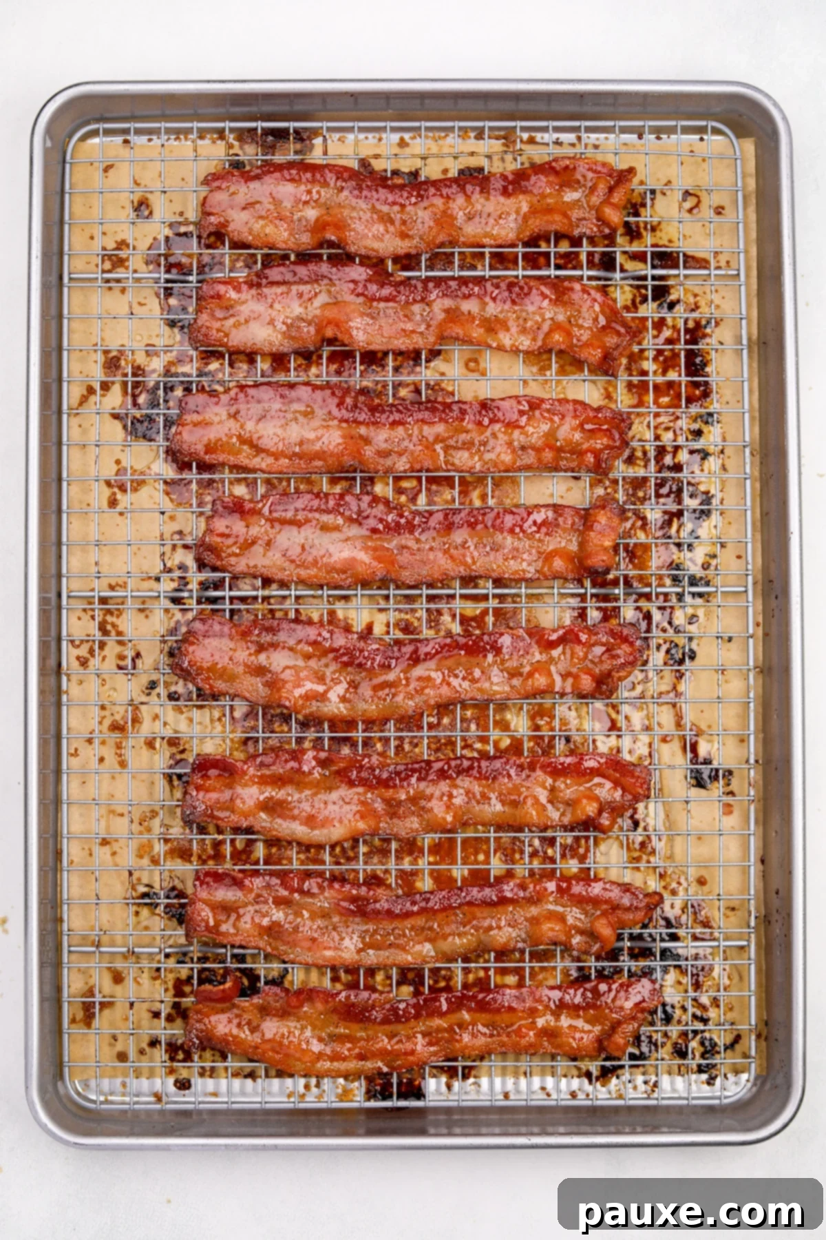 Crispy Caramelized Bacon 9 Crispy cooked bacon on a wire rack set inside of a baking sheet.