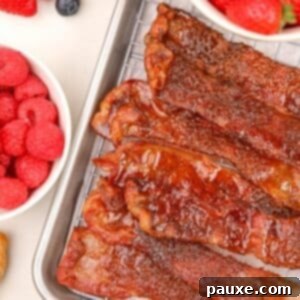 Air Fryer Millionaire's Bacon 8 A stack of glazed bacon slices piled on top of a wire rack.