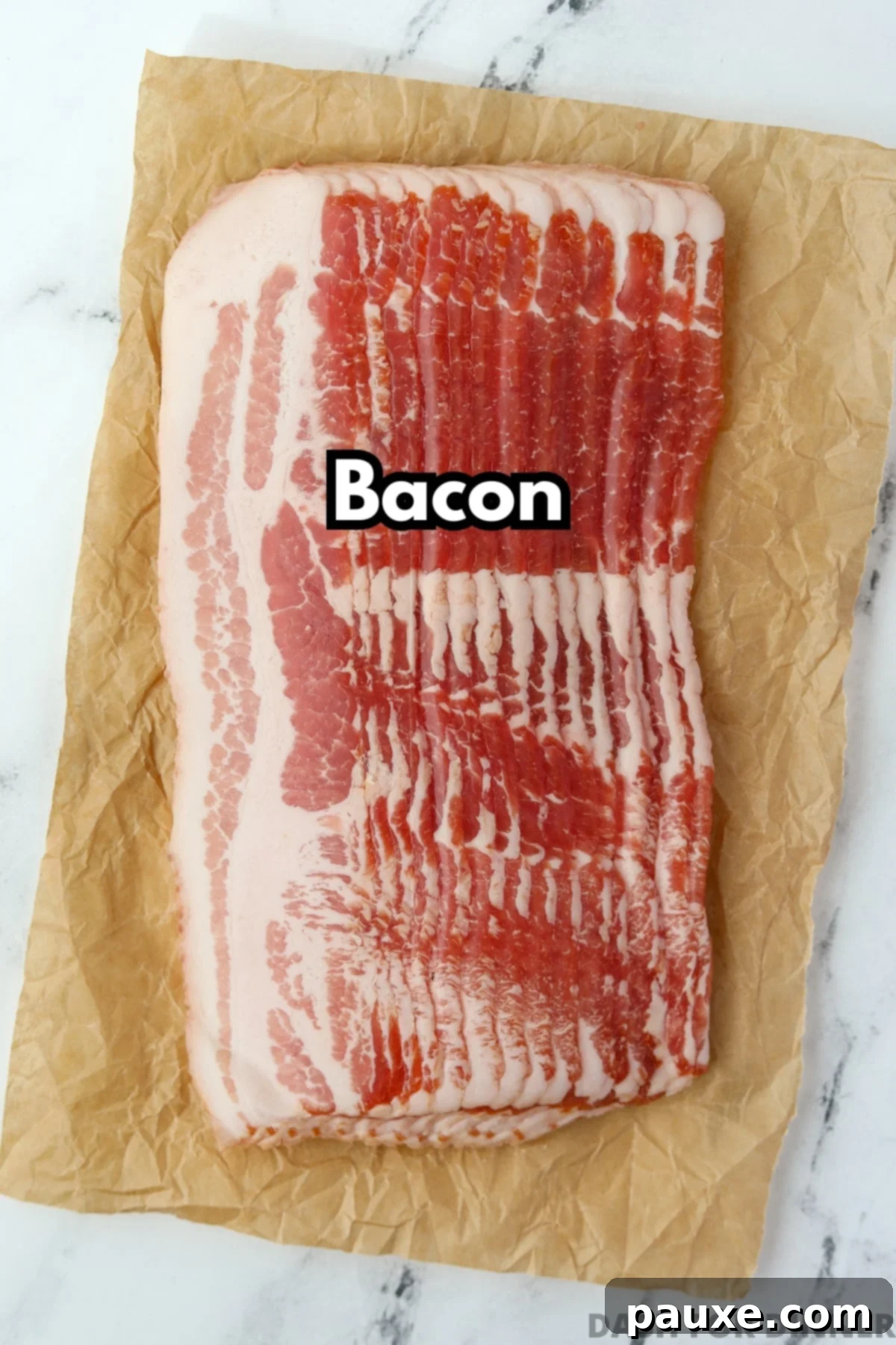 Crafting Crispy Homemade Bacon Bits 3 A pristine package of raw, streaky bacon rests on a sheet of parchment paper, highlighting the sole ingredient needed for homemade bacon bits.