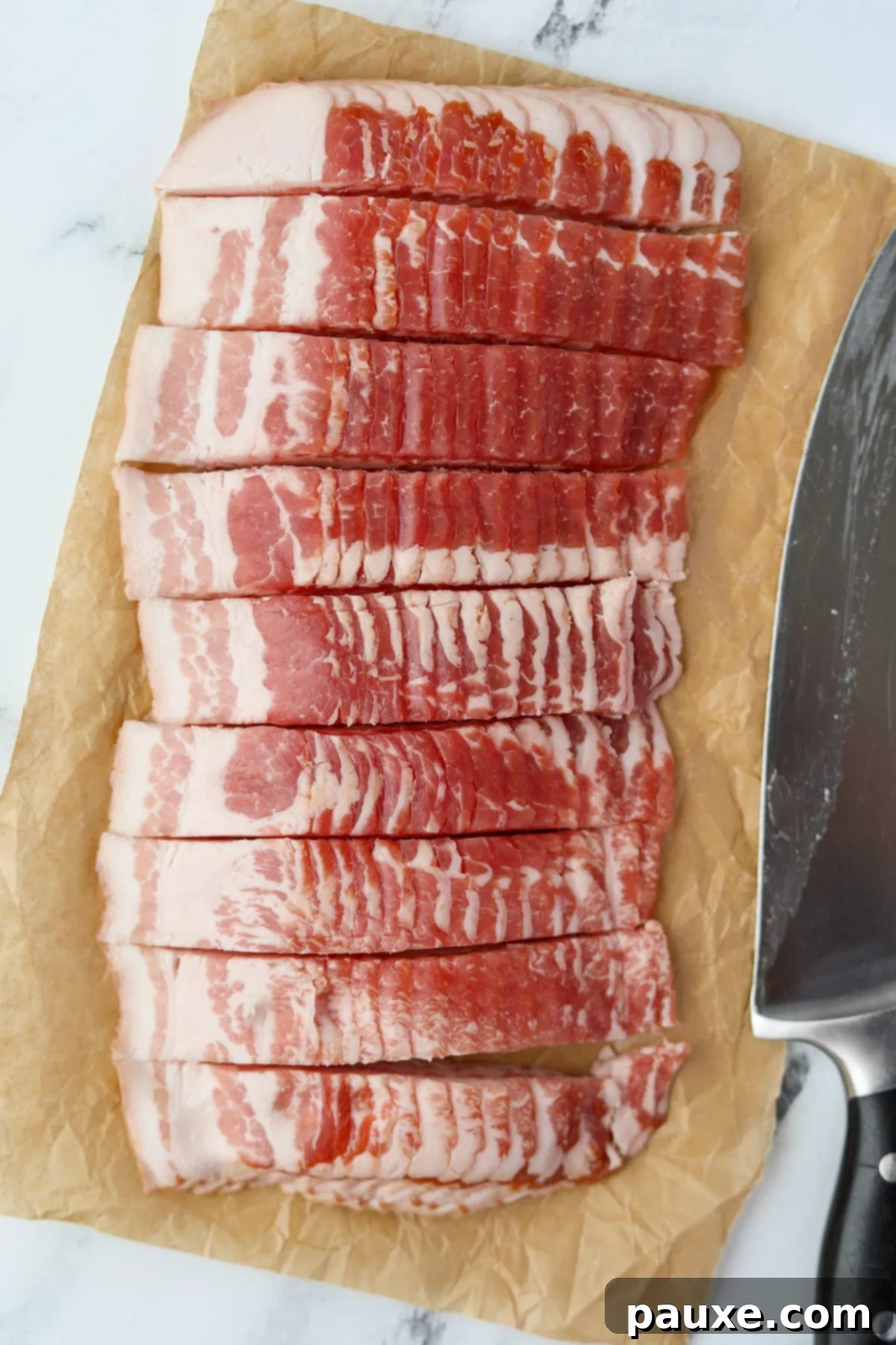 Crafting Crispy Homemade Bacon Bits 4 Raw bacon slices neatly arranged and partially cut into uniform ¾-inch rectangular pieces along their length, ready for the next chop.