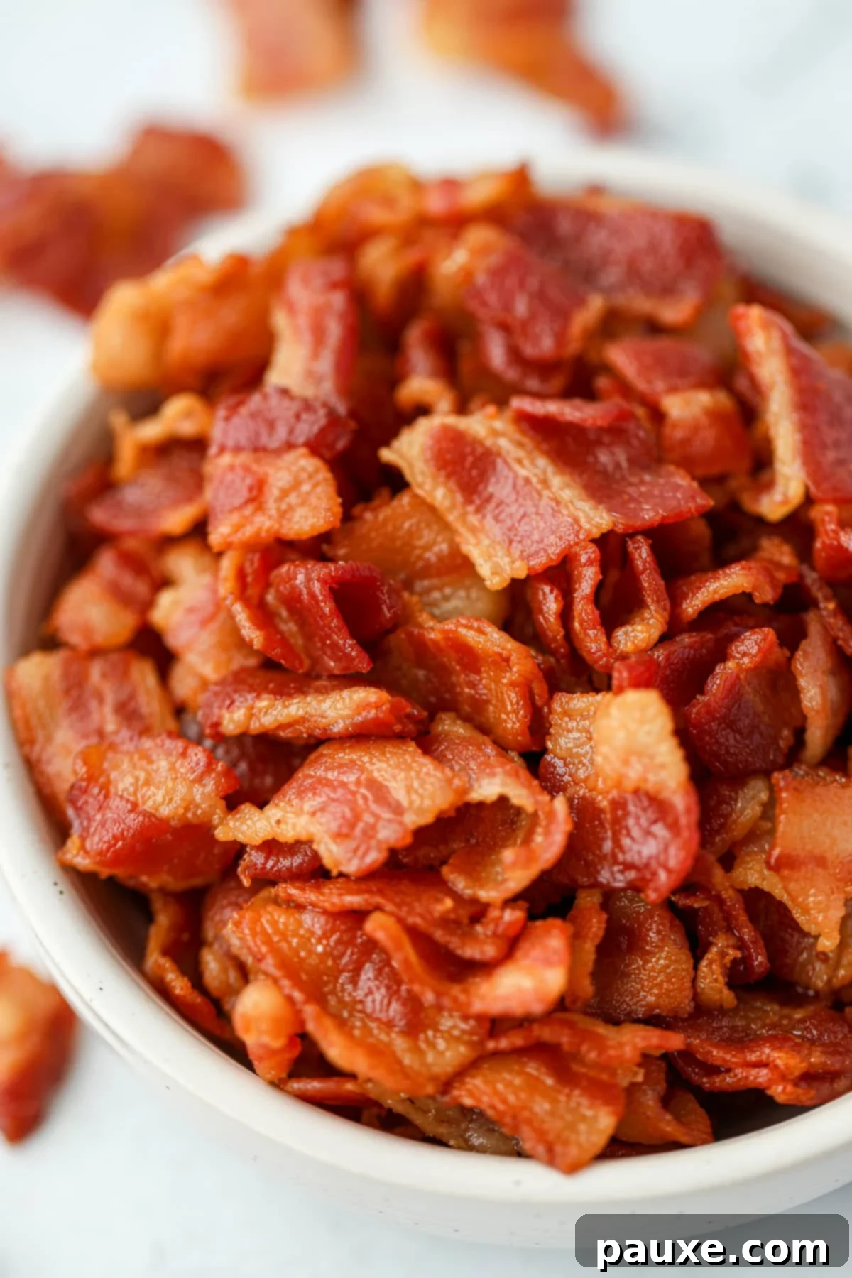 Crafting Crispy Homemade Bacon Bits 10 A high-resolution close-up image of cooked bacon bits, showcasing their glistening, golden-brown hue and irresistible crispy texture.