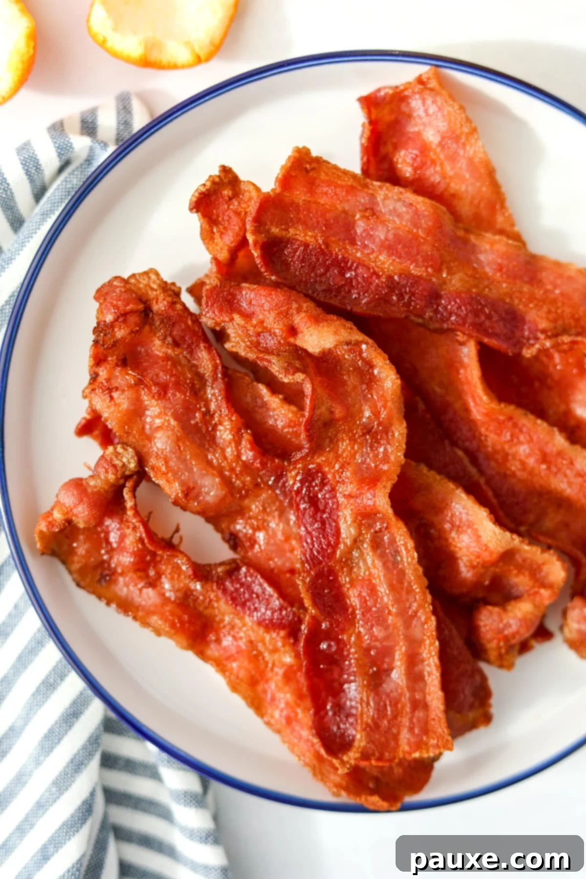 Crispy Air Fryer Bacon 2 Perfectly cooked, crispy bacon slices fresh out of the air fryer, glistening with smoky flavor.