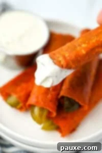 Zesty Brined Cheese Bites 15 Dipping a crispy cheese pickle into a bowl of ranch dressing, highlighting the fresh, cooked result.