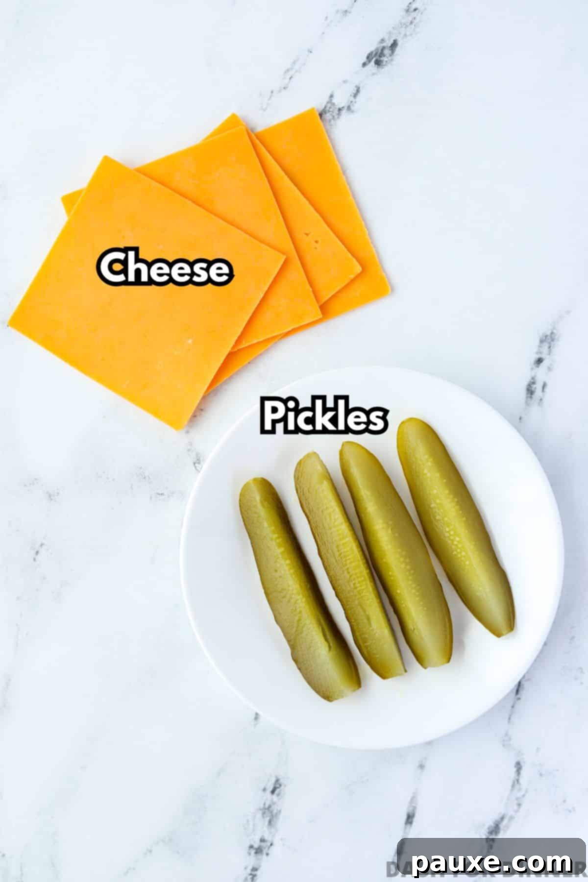 Zesty Brined Cheese Bites 3 Several slices of cheese and several dill pickle spears on a marble background, perfectly arranged and ready for cooking.