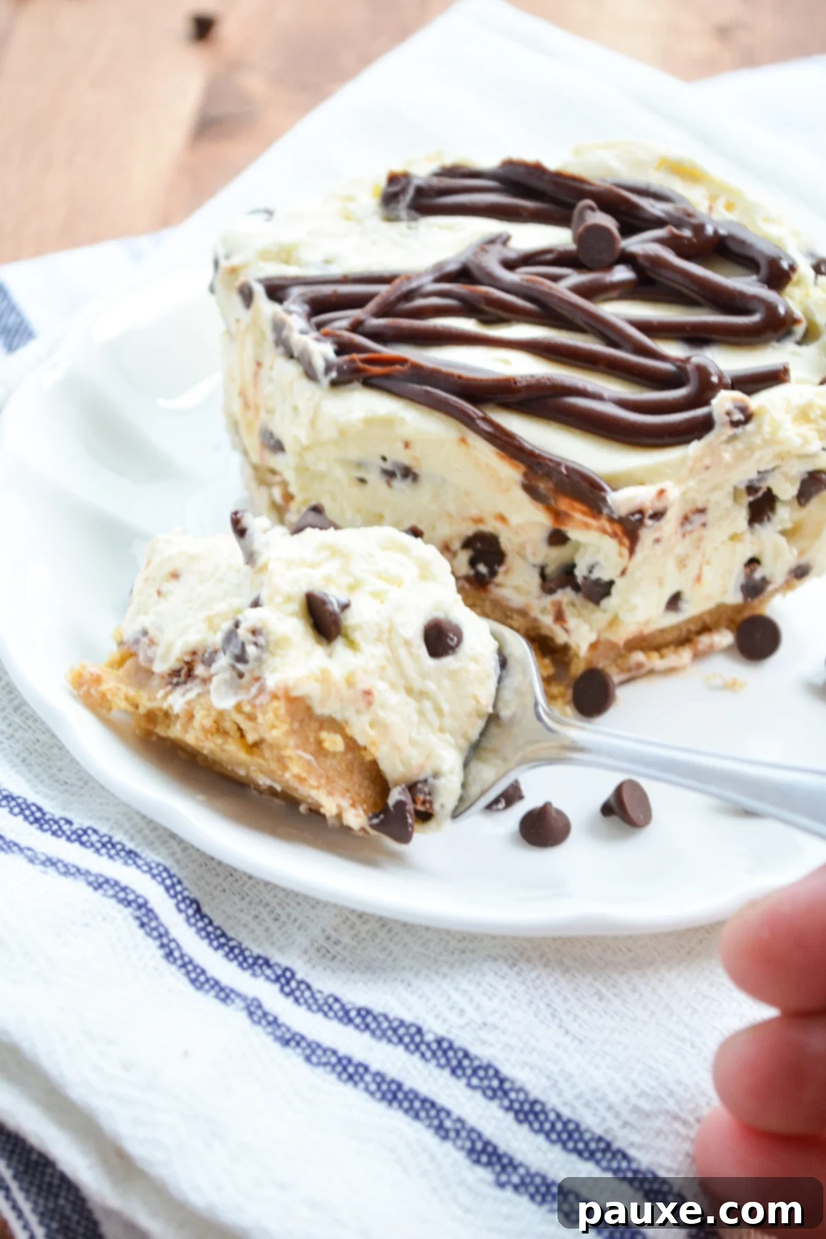 Easy No-Bake Chocolate Chip Cheesecake 8 A fork taking a bite out of a perfectly chilled No-Bake Chocolate Chip Cheesecake slice.