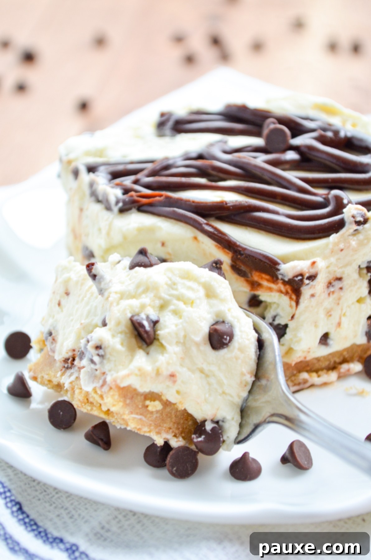 Easy No-Bake Chocolate Chip Cheesecake 9 A fork lifts a generous bite of the decadent No-Bake Chocolate Chip Cheesecake, showcasing its creamy texture and chocolate chips.