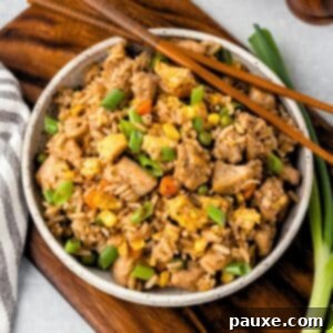 The Art of Benihana Chicken Fried Rice 8 A bowl of chicken fried rice with chopsticks on the side.