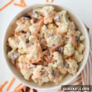 Spiced Cauliflower Salad with Tahini 10 A bowl of cauliflower salad dotted with cheese and bacon.