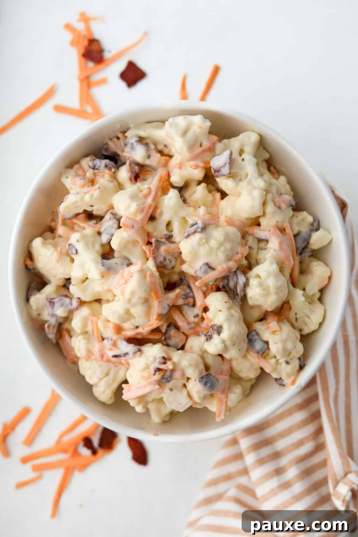 Spiced Cauliflower Salad with Tahini 7 A bowl of cauliflower salad dotted with bacon and cheese.