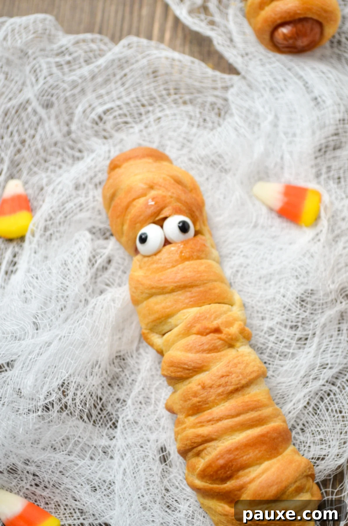 Spooky Air Fryer Mummy Dogs 9 A close-up of a finished Air Fryer Mummy Dog, perfectly wrapped and adorned with candy eyes.