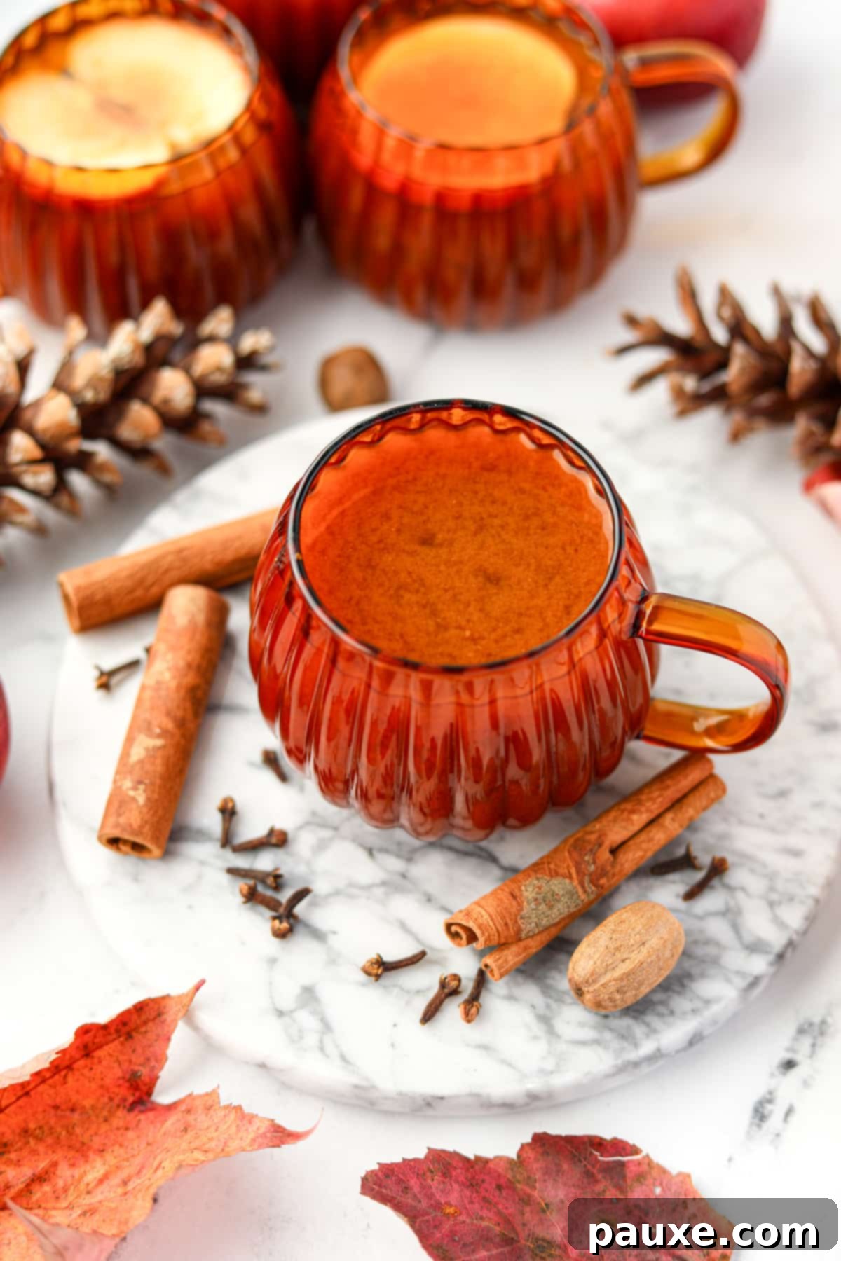 Golden Pumpkin Harvest Brew 6 A glass orange mug filled with pumpkin cider, ready to be enjoyed.