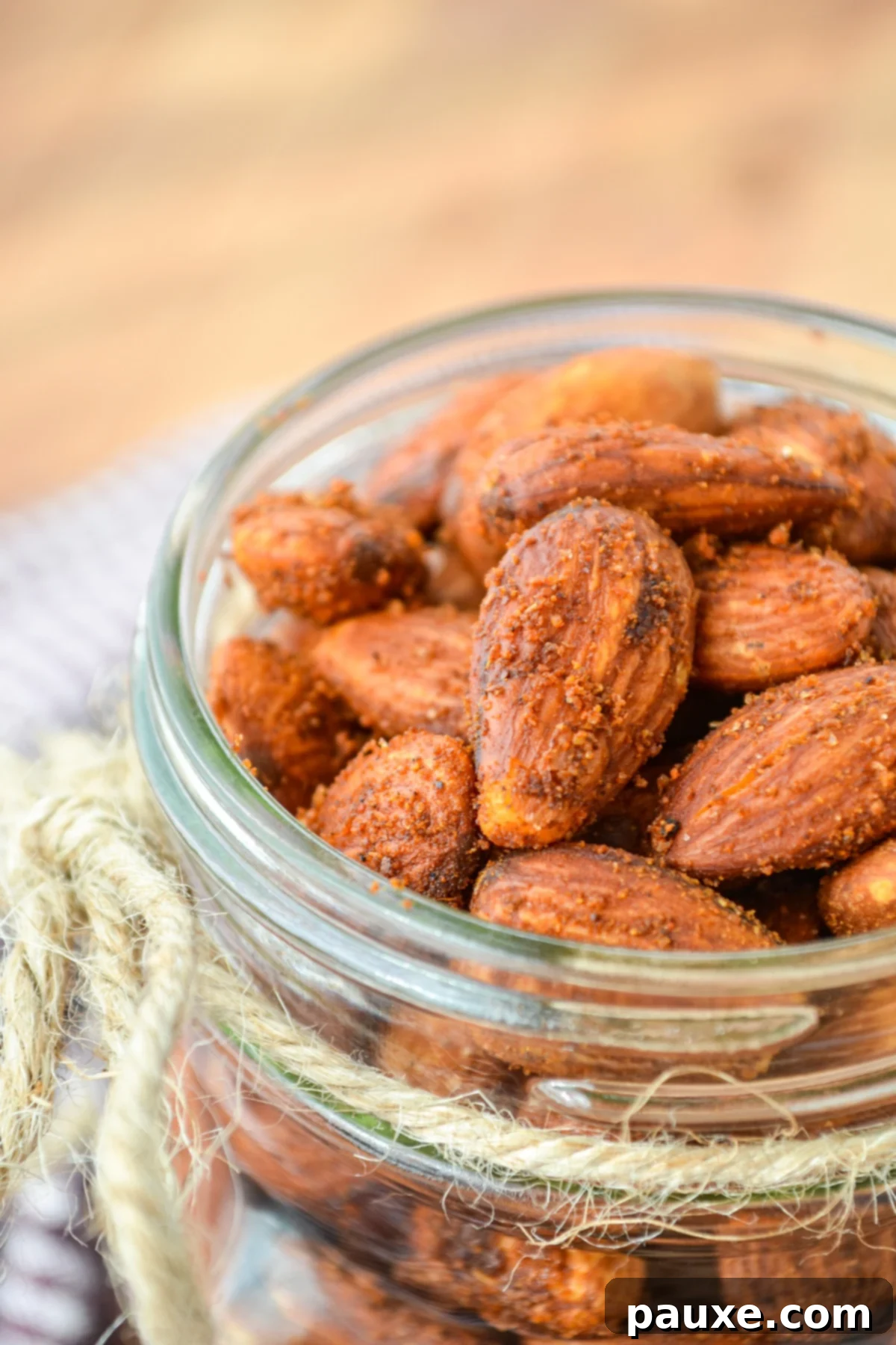Crispy Golden Air Fryer Almonds 2 A pint jar filled with roasted almonds, ready to be enjoyed as a healthy snack.