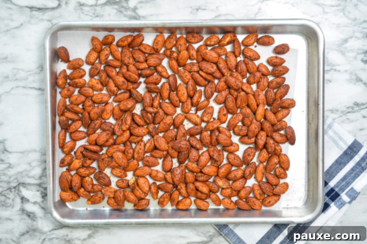 Crispy Golden Air Fryer Almonds 6 A sheet pan of roasted almonds, cooling from the air fryer.