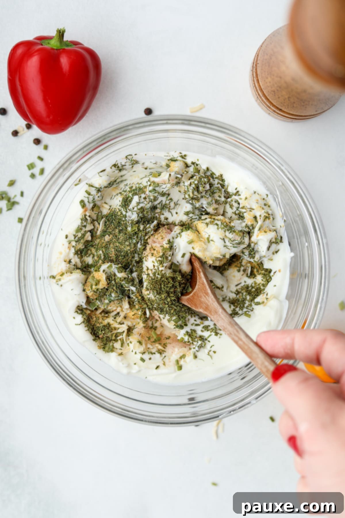 Healthy Greek Yogurt Ranch 5 Stirring seasonings into a bowl of Greek yogurt.