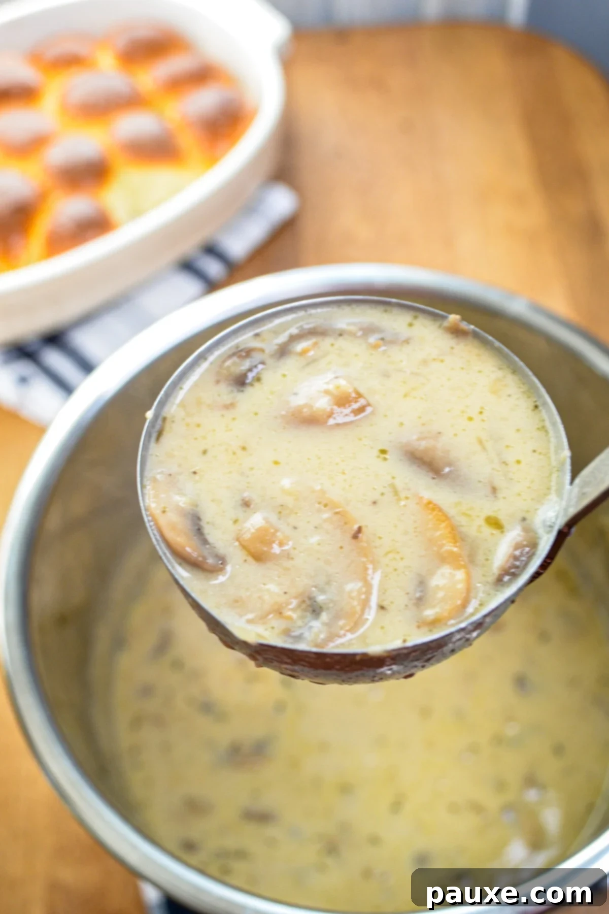Instant Pot Creamy Mushroom Comfort 8 A ladle full of mushroom soup lifting out of an Instant Pot