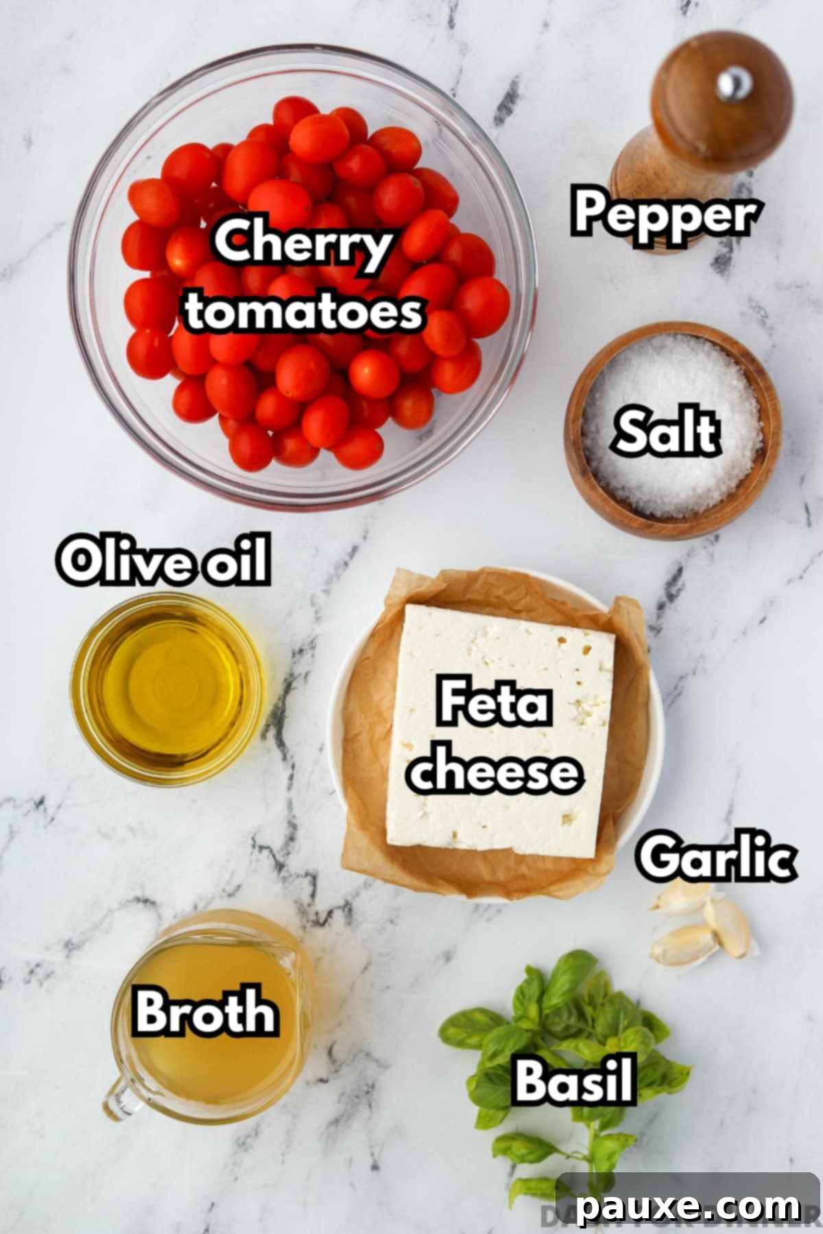 Roasted Feta Tomato Soup 3 A flat lay showing the essential ingredients for roasted tomato and feta soup: bright red cherry tomatoes, a block of creamy feta, olive oil, fresh basil, and garlic.