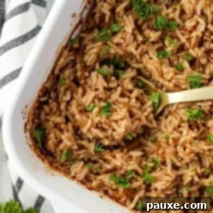 Rich Beef Consommé Rice 8 Scooping rice from a baking dish.