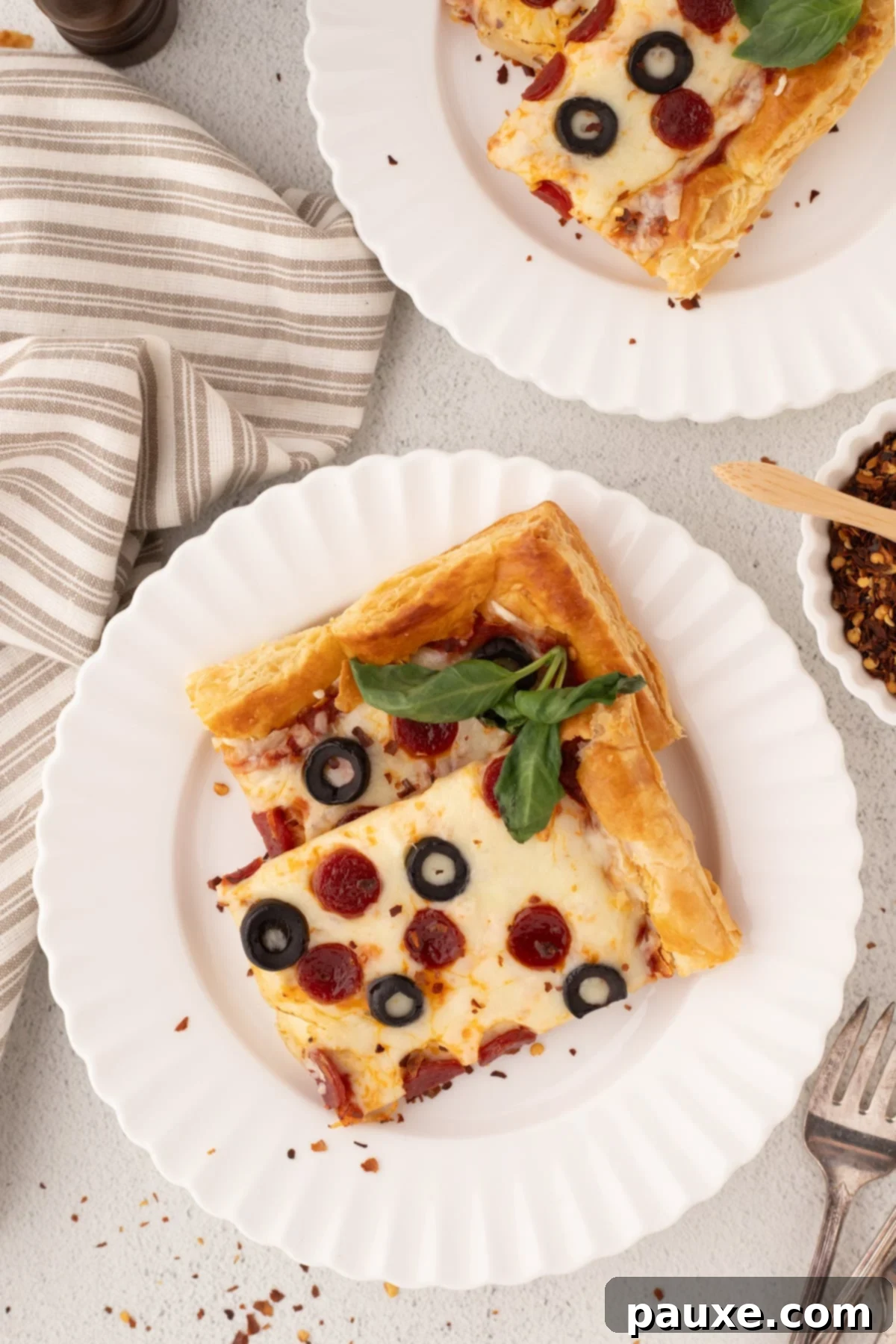 Crispy Puff Pizza 6 Slices of pizza topped with pepperoni and garnished with basil, ready to be served.