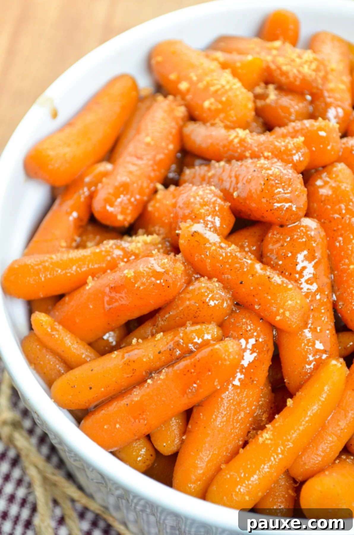 Caramelized Maple Brown Sugar Slow Cooker Carrots 9 A beautifully presented serving dish filled to the brim with luscious maple glazed carrots, ready to be enjoyed.