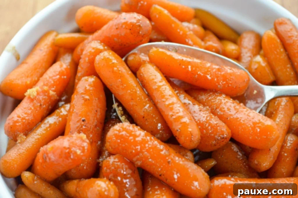Caramelized Maple Brown Sugar Slow Cooker Carrots 10 A festive baking dish brimming with succulent glazed baby carrots, artfully sprinkled with a touch of brown sugar.