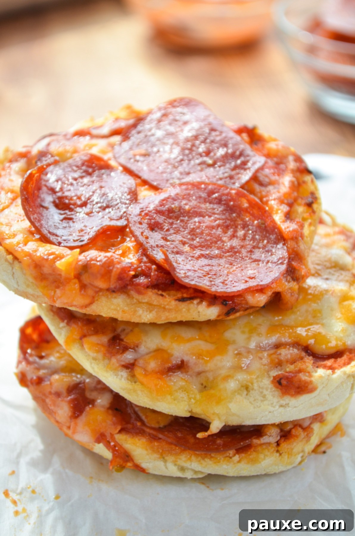 Quick Air Fryer Muffin Pizzas 8 A perfectly stacked trio of Air Fryer English Muffin Pizzas, ready to eat.