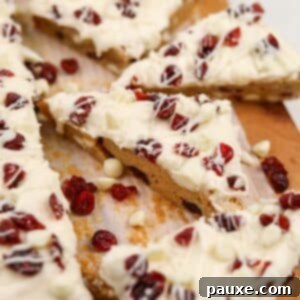 Ruby Red Cranberry Blondies 12 A triangular cranberry bliss bar topped with dried cranberries and cream cheese frosting.