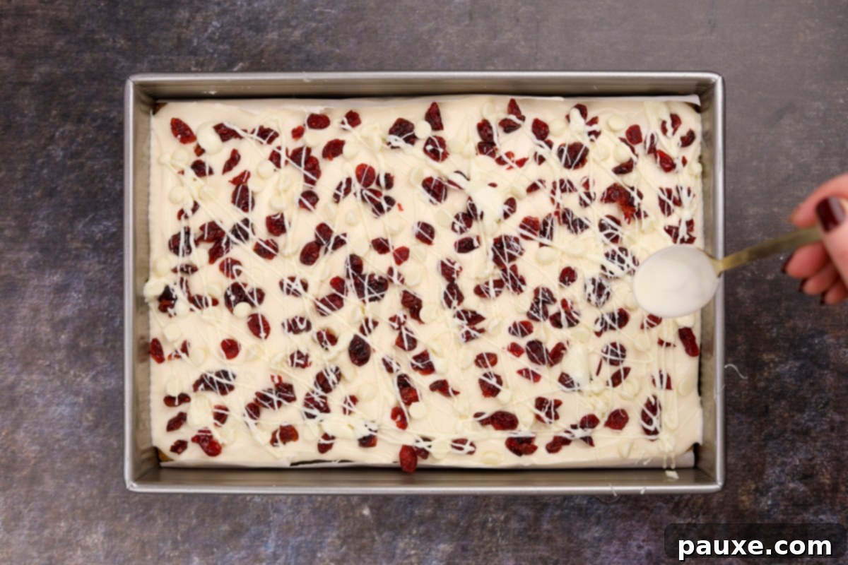 Ruby Red Cranberry Blondies 7 Drizzling white chocolate over cream cheese frosting and dried cranberries.