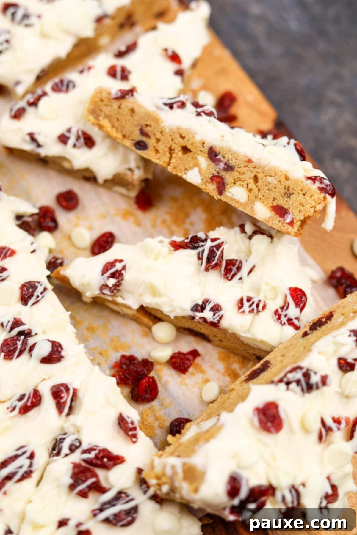 Ruby Red Cranberry Blondies 9 A side view of a homemade cranberry bliss bar, showing the white chocolate and cranberry dotted interior.