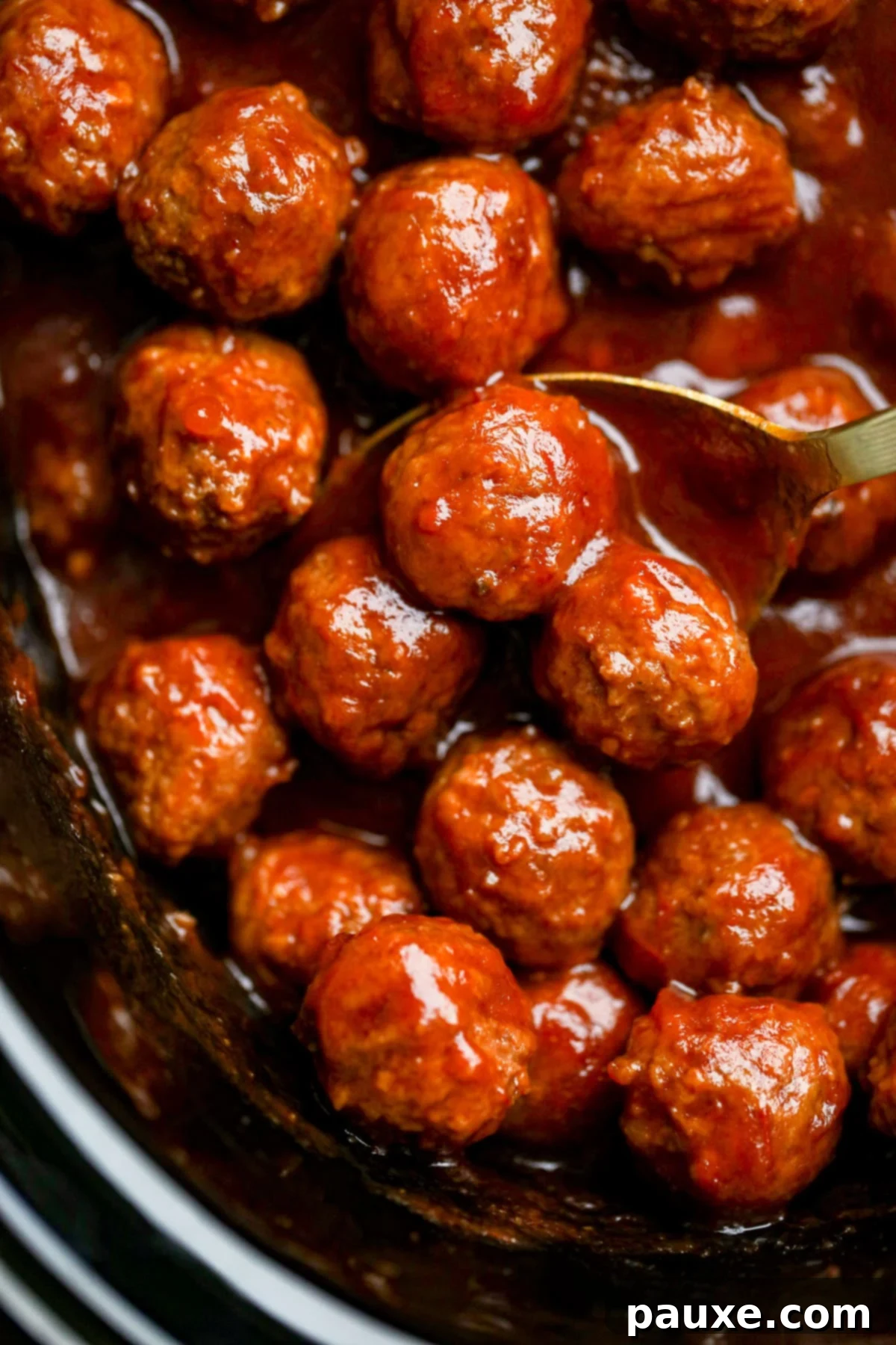 Slow Cooker Cranberry Glazed Meatballs 2 A crock pot filled with saucy meatballs.