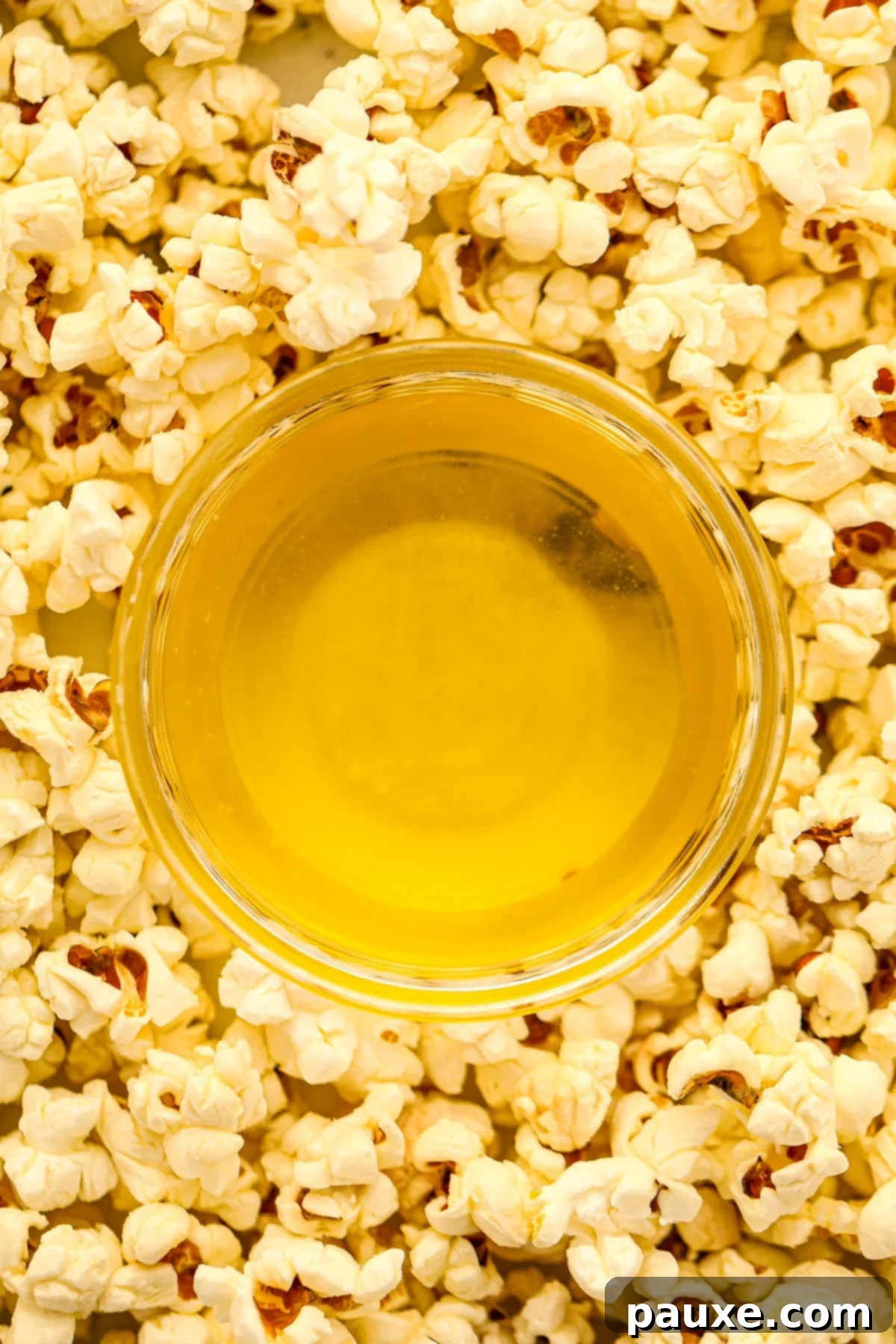 Golden Popcorn Topping 2 Clarified butter in a small dish surrounded by popcorn.
