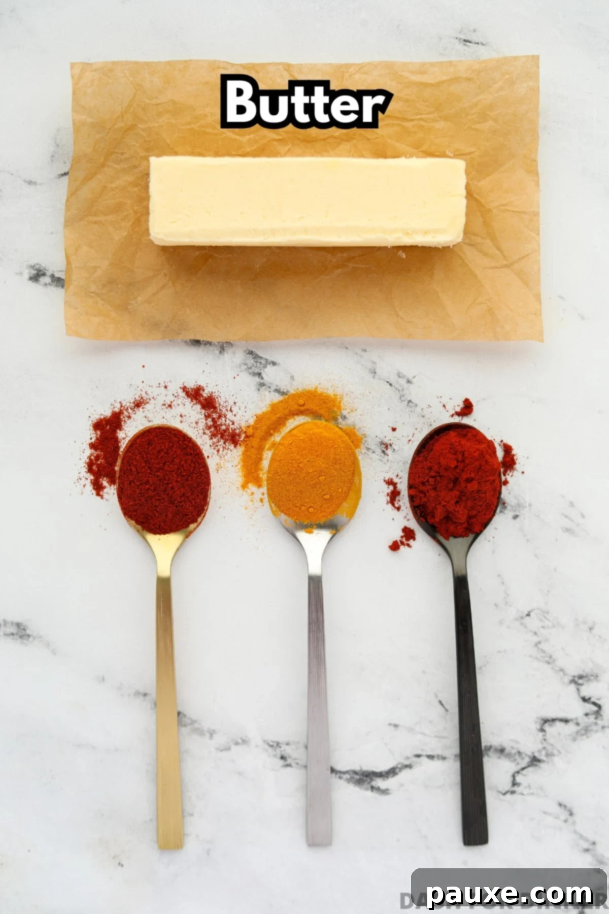Golden Popcorn Topping 3 The ingredients needed to make popcorn butter, including a stick of butter and optional spices for color.