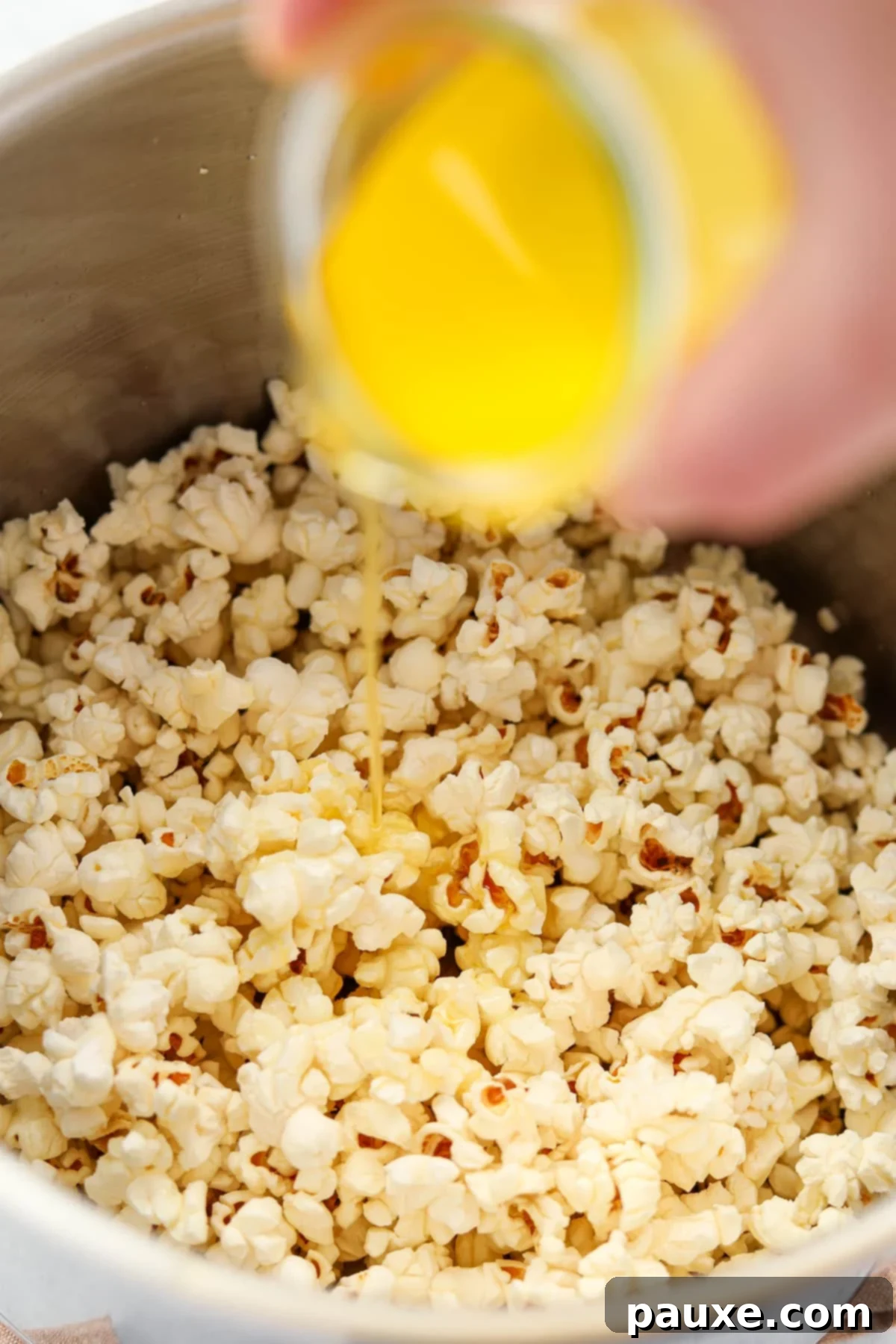 Golden Popcorn Topping 6 Drizzling melted butter over popped kernels.