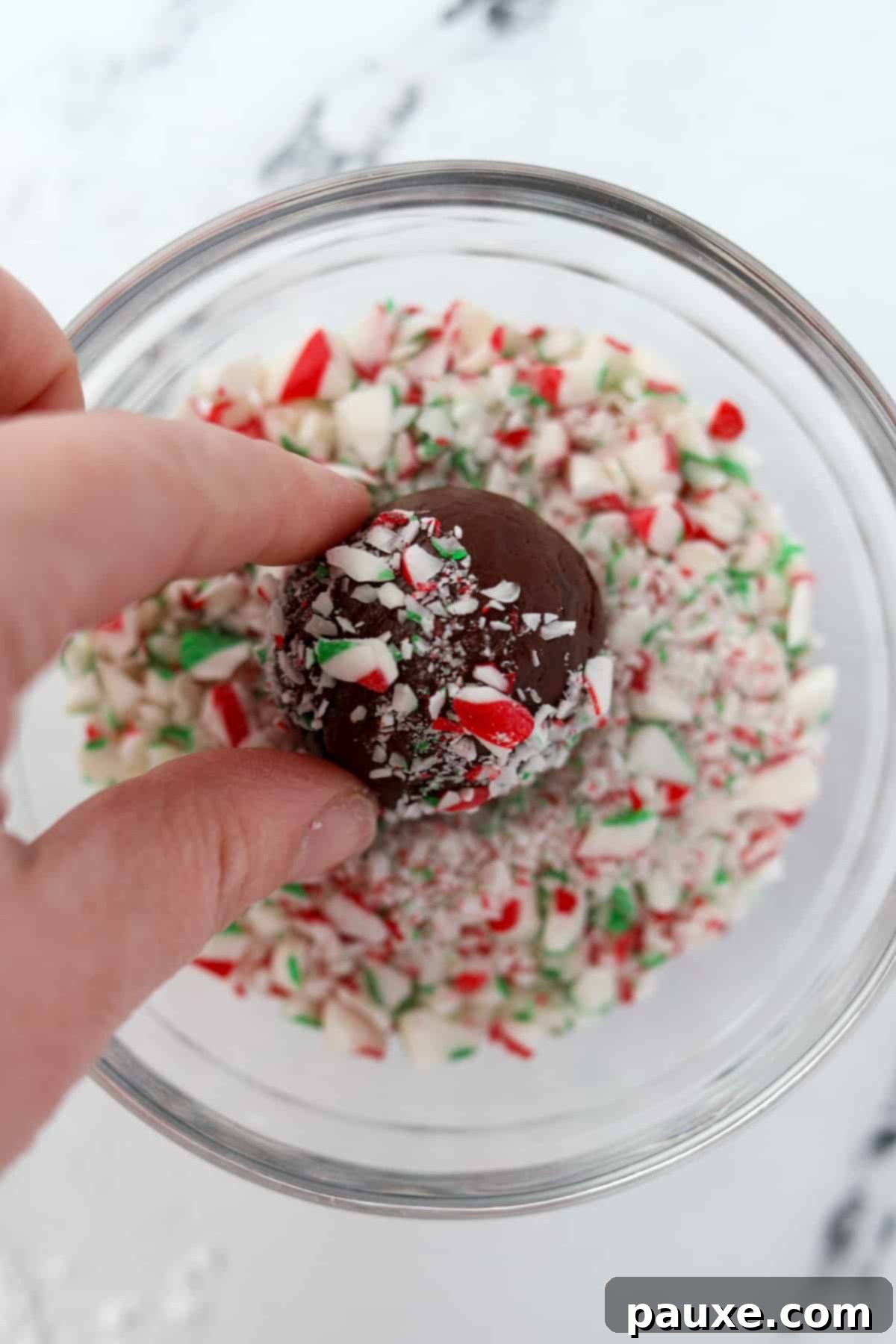 Refreshing Peppermint Truffles 8 Rolling a chocolate ball in crushed candy cane dust.