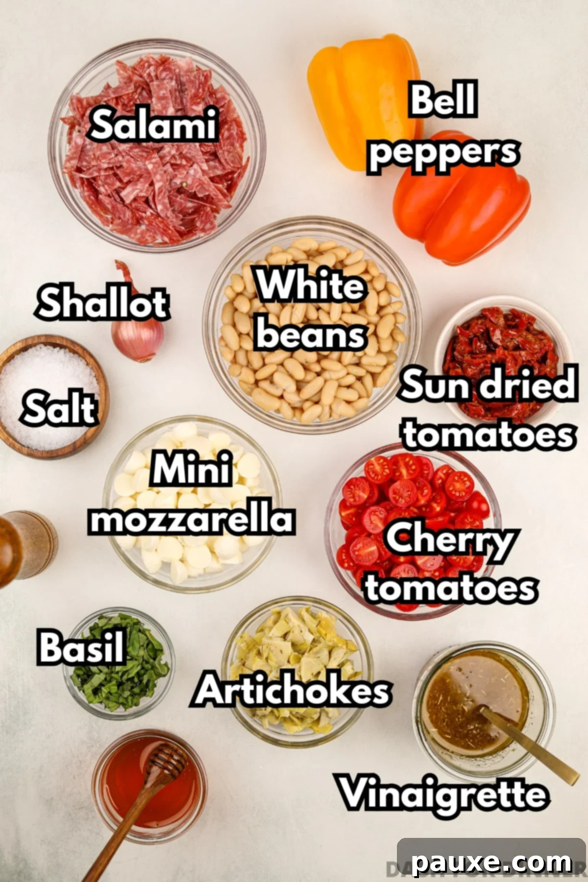 Hearty Italian Bean Medley 3 The ingredients needed to make Italian bean salad, including salami, mozzarella, sundried tomatoes, and more.