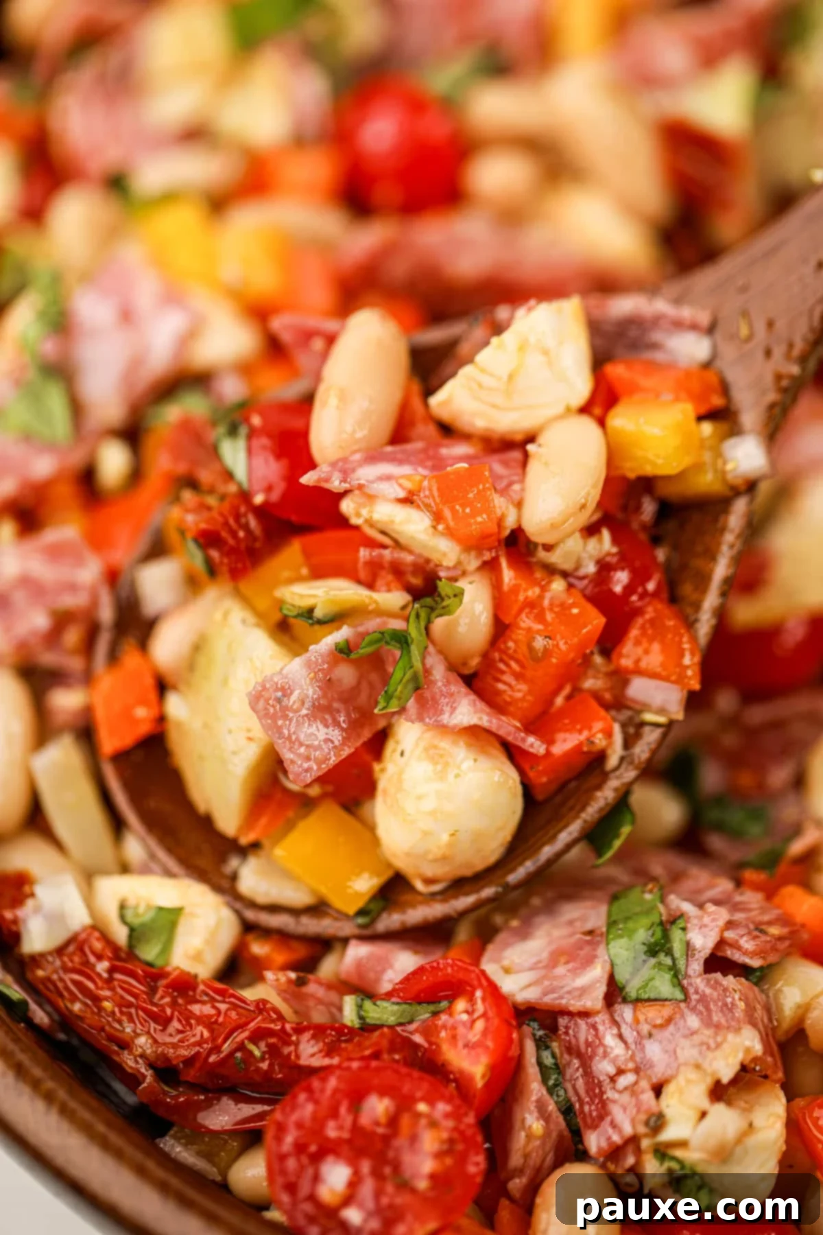 Hearty Italian Bean Medley 6 A wooden spoon taking a portion of bean salad from a wooden bowl.