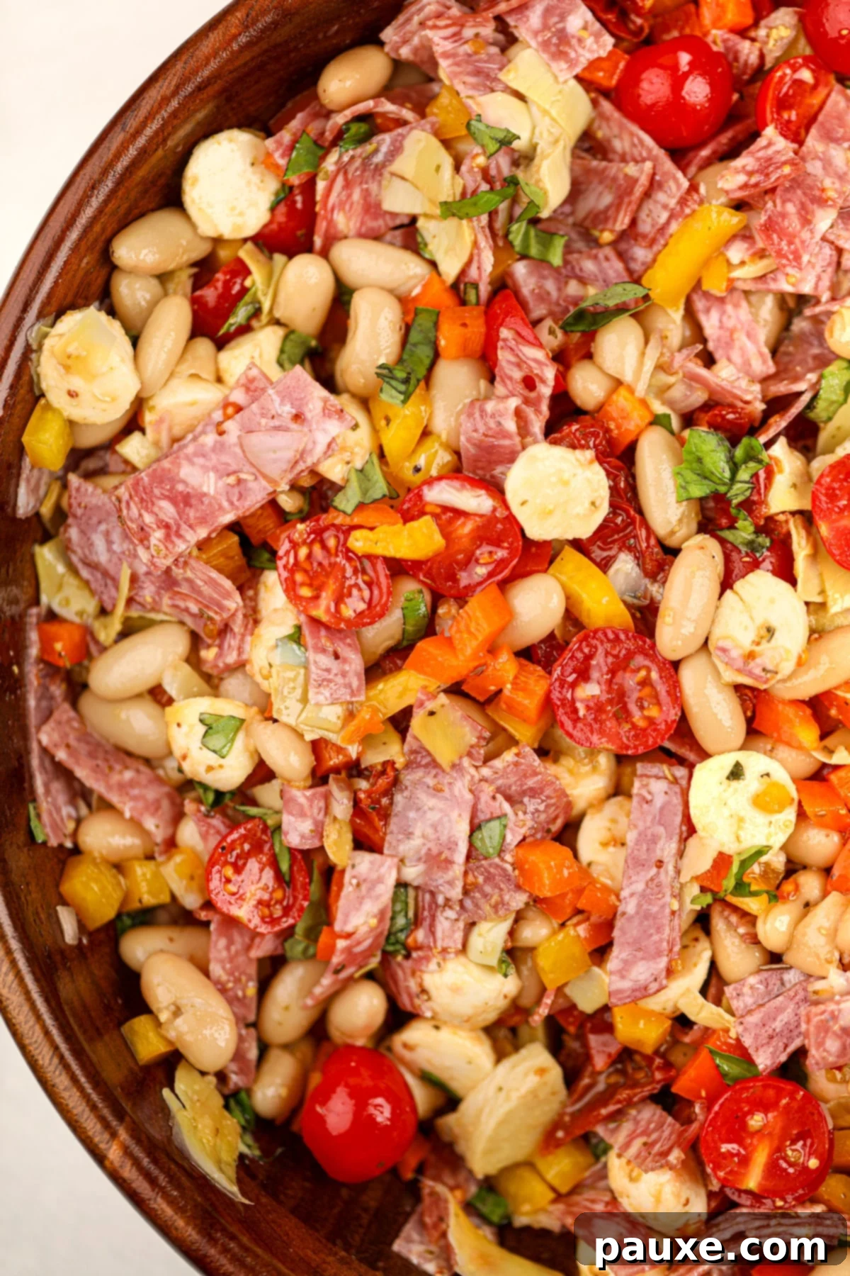 Hearty Italian Bean Medley 7 A wooden bowl filled with a colorful bean salad.