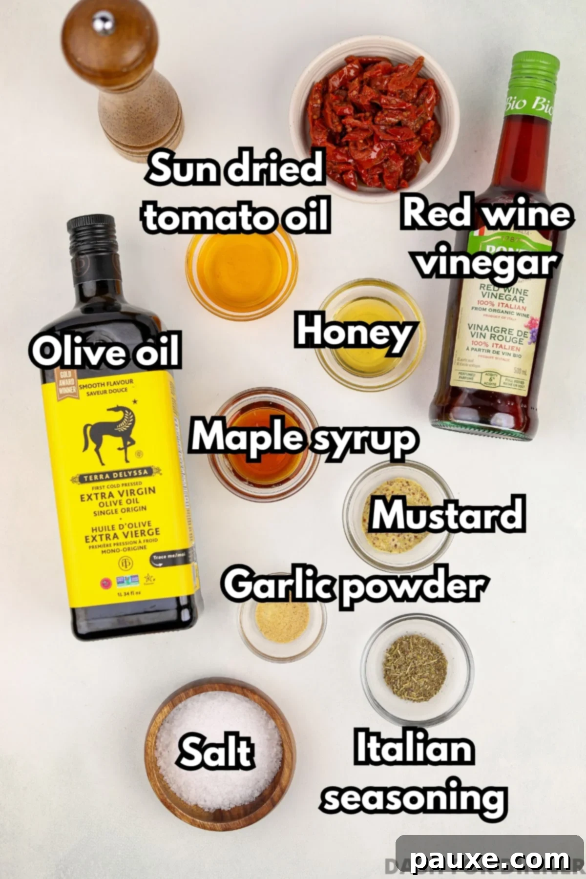 Mediterranean Sunset Vinaigrette 3 The ingredients needed to make homemade vinaigrette, including honey, vinegar, olive oil, and flavoring ingredients.