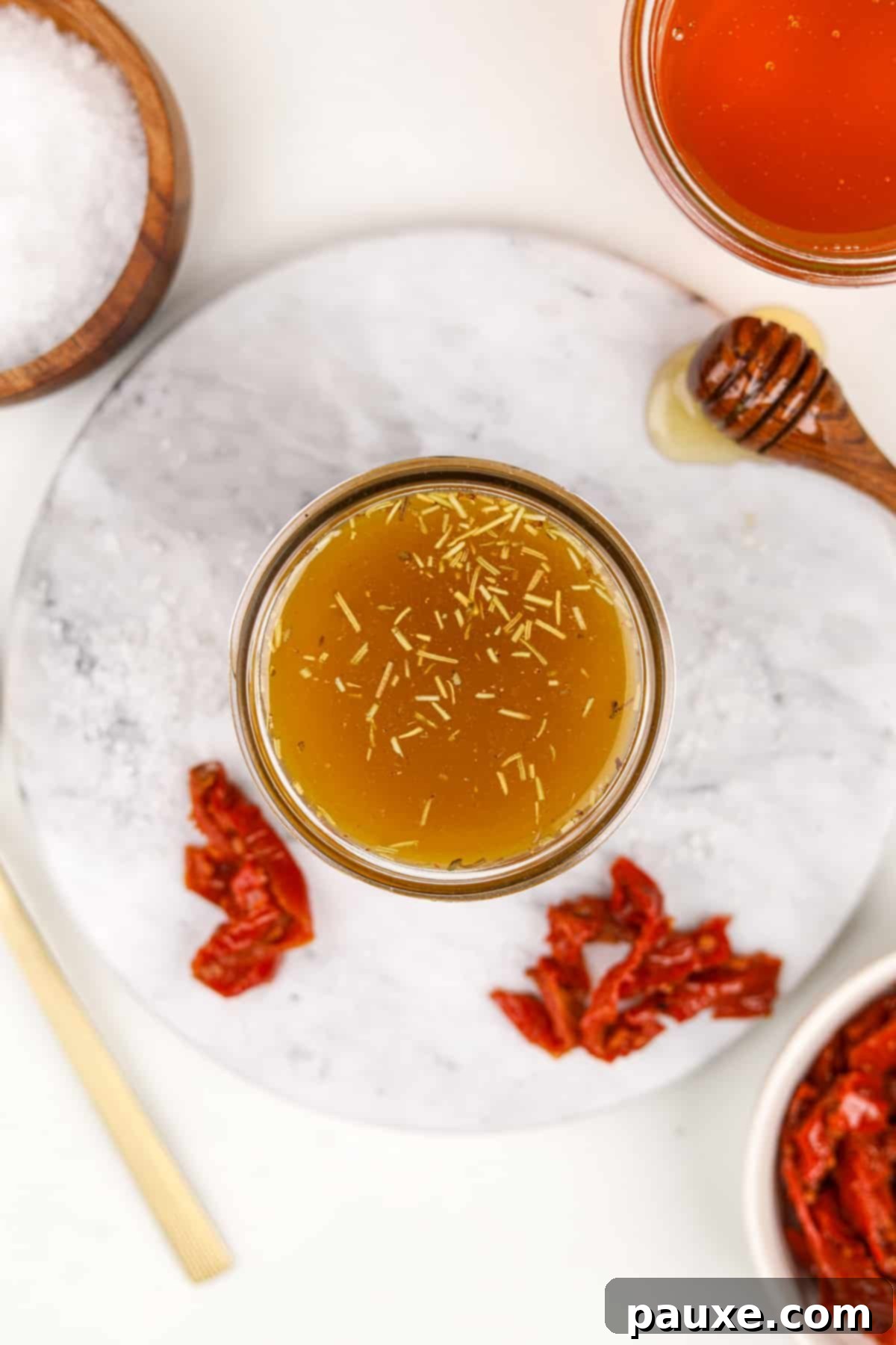 Mediterranean Sunset Vinaigrette 7 A small jar of homemade vinaigrette with dried spices floating.