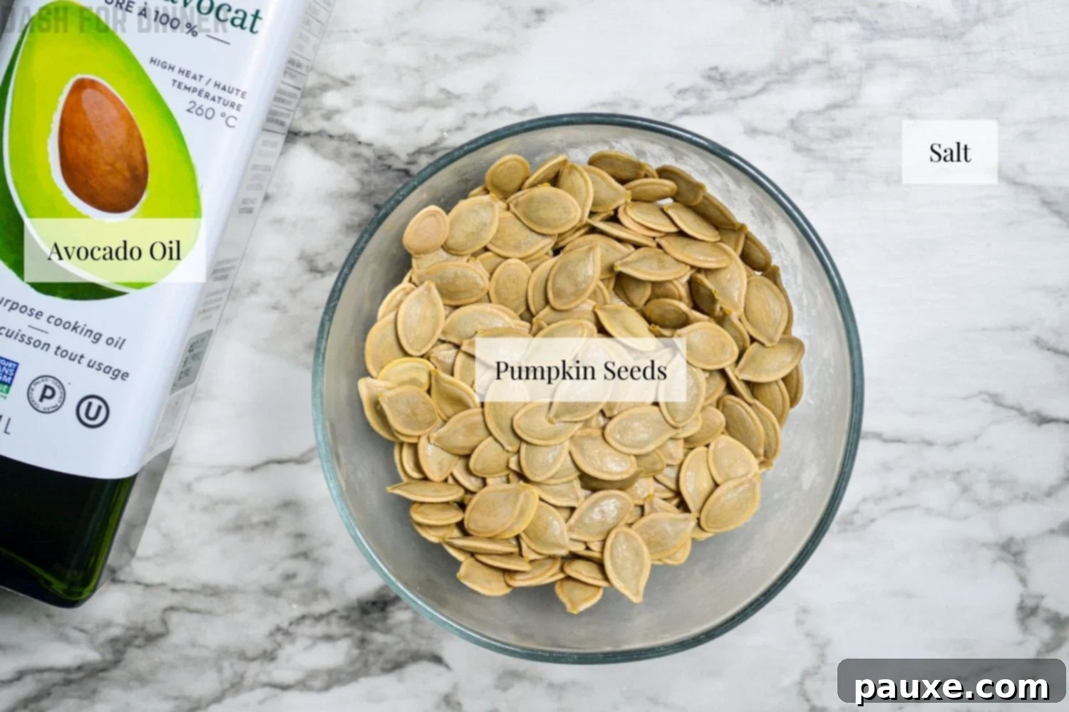 Crispy Air Fryer Pumpkin Seeds 3 A simple arrangement of the core ingredients for roasted pumpkin seeds: raw, cleaned pumpkin seeds, a salt shaker, and a bottle of avocado oil.