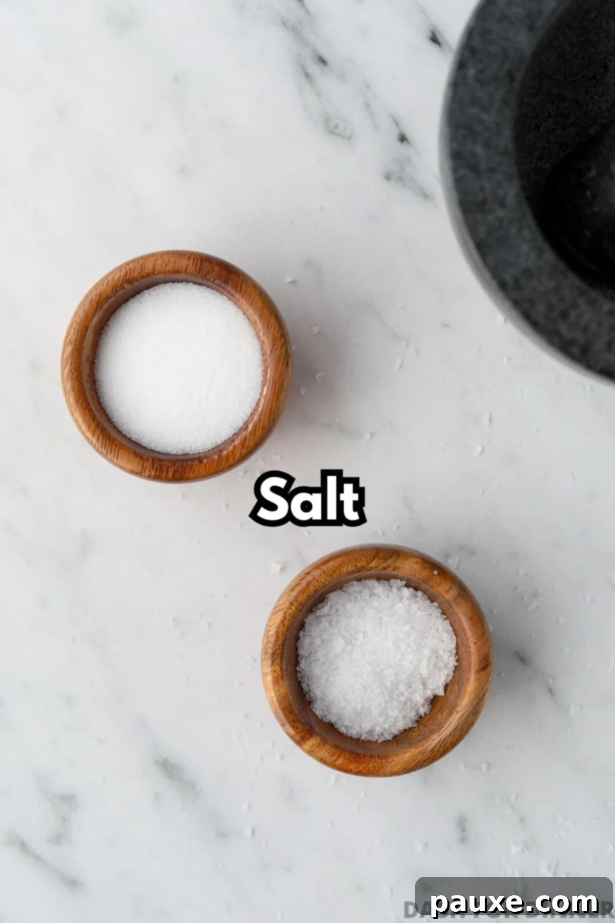 Artisan Popcorn Dust 3 Two small wooden bowls filled with both fine salt and flaky salt.