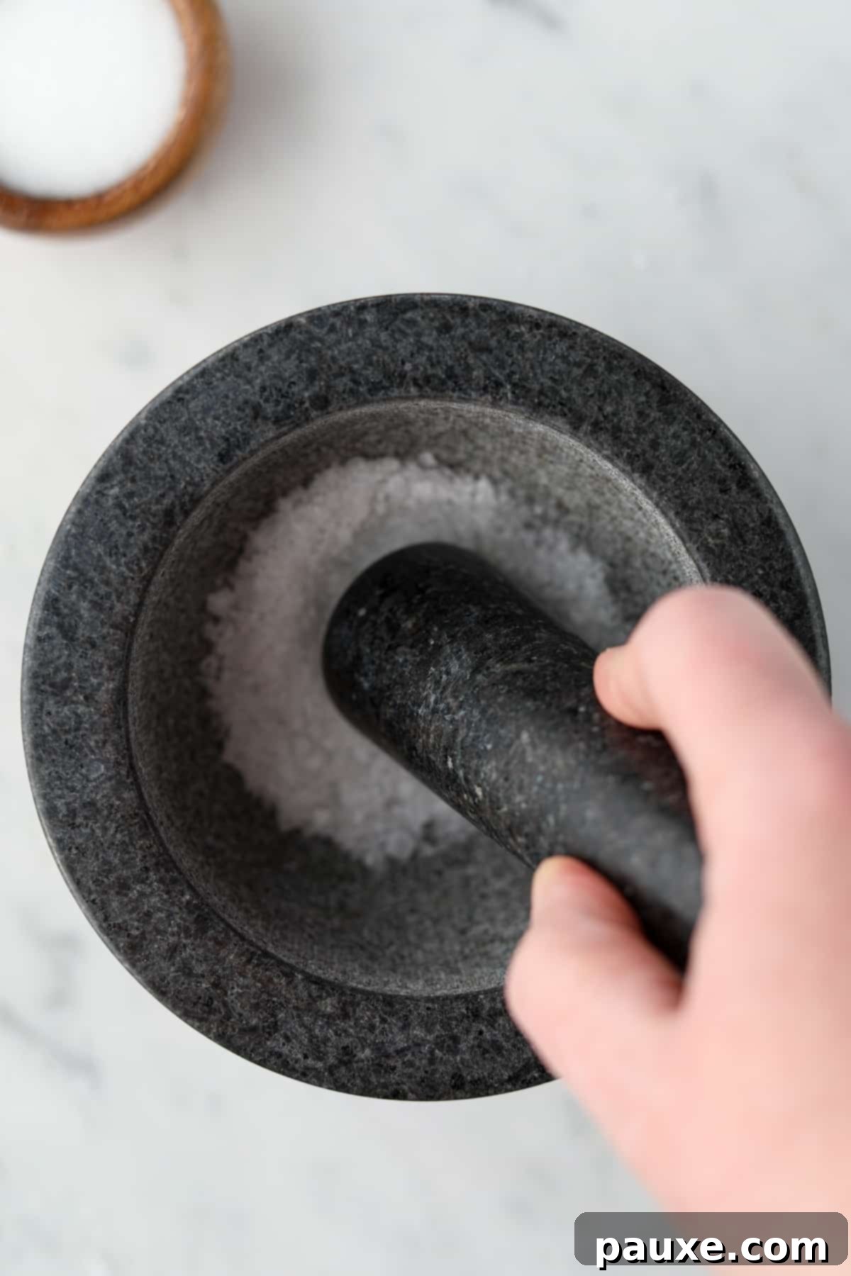Artisan Popcorn Dust 4 Crushing salt in a mortar and pestle.