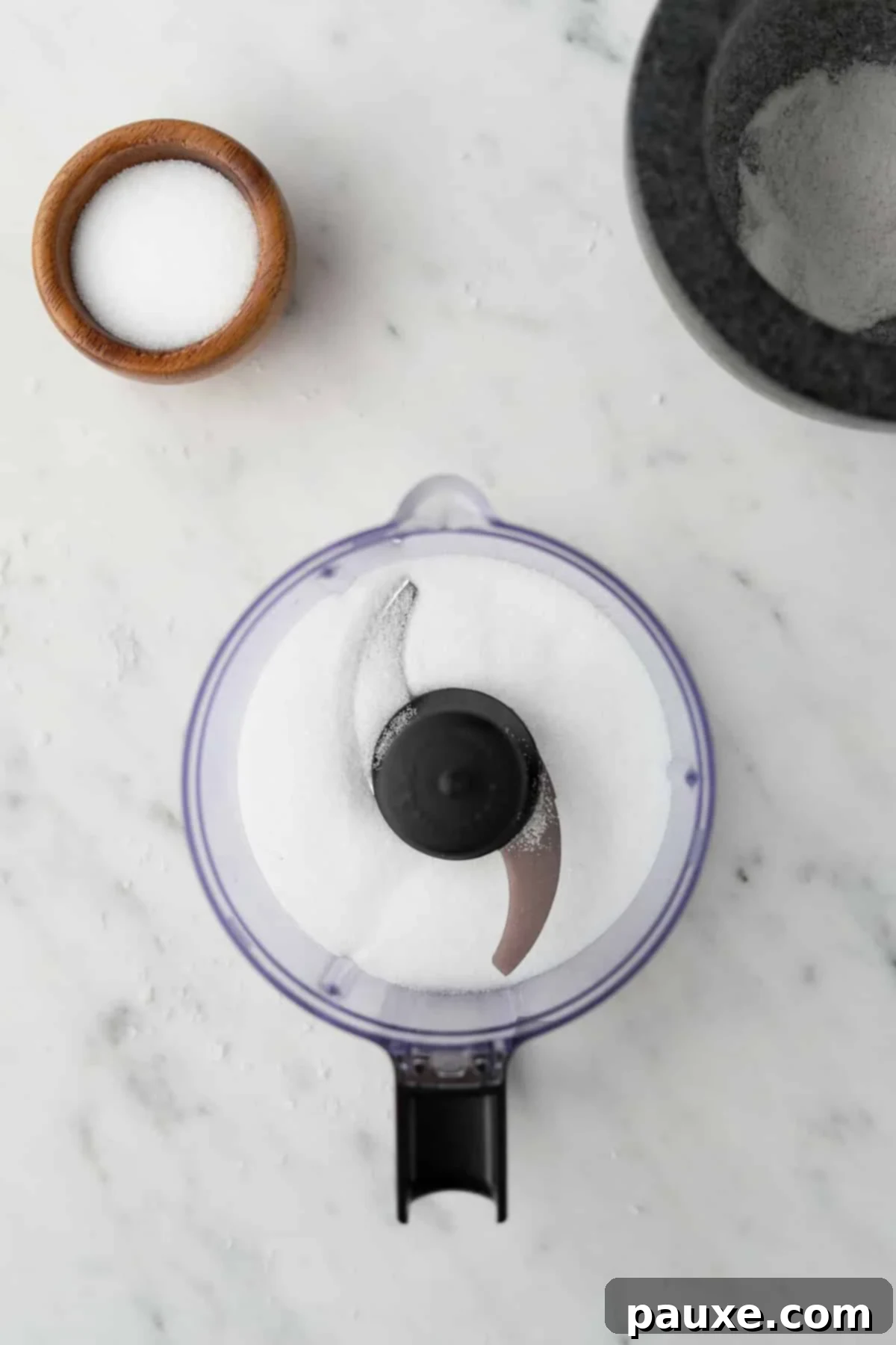 Artisan Popcorn Dust 7 A small food processor filled part way with salt.