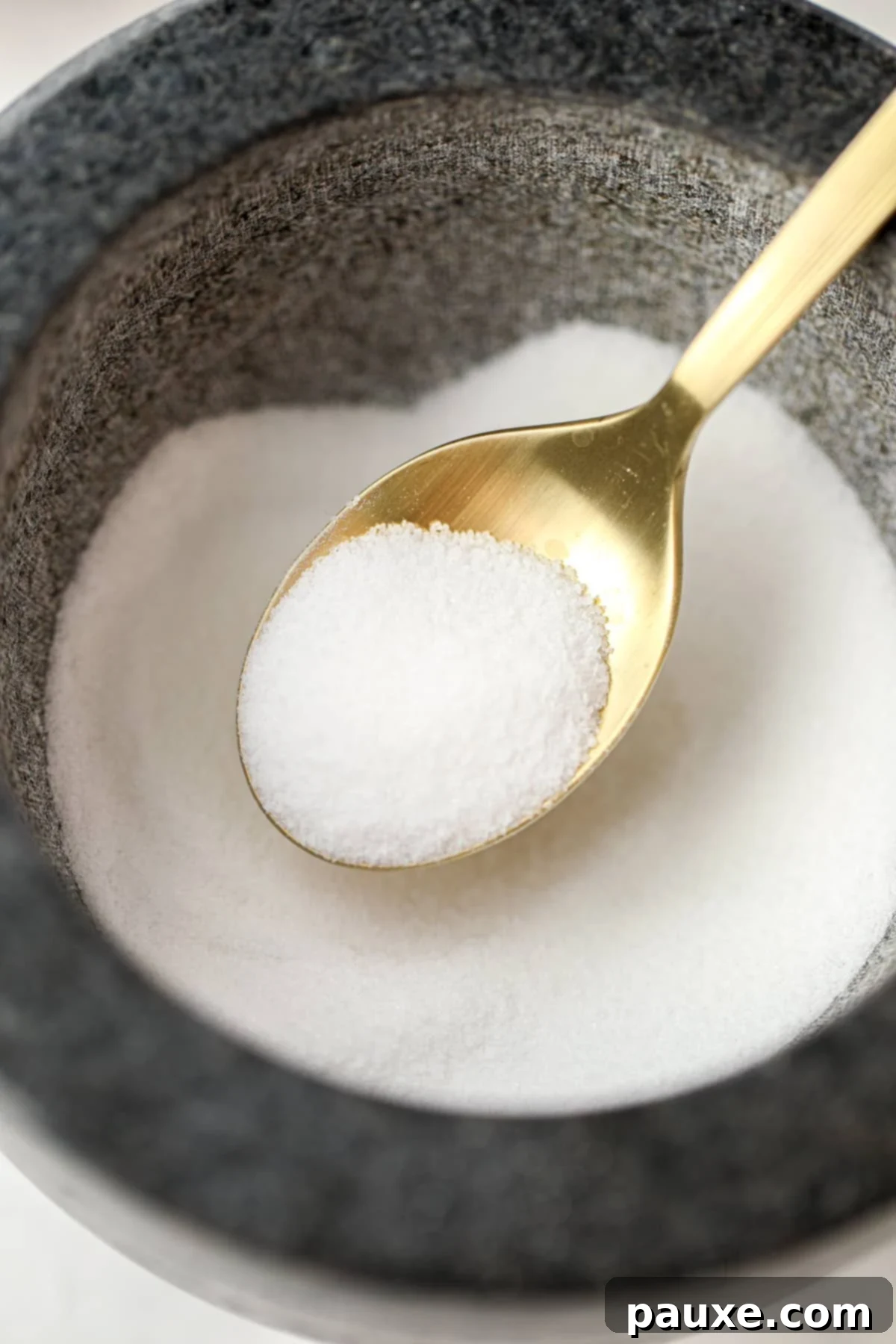 Artisan Popcorn Dust 8 Scooping salt from a mortar bowl.